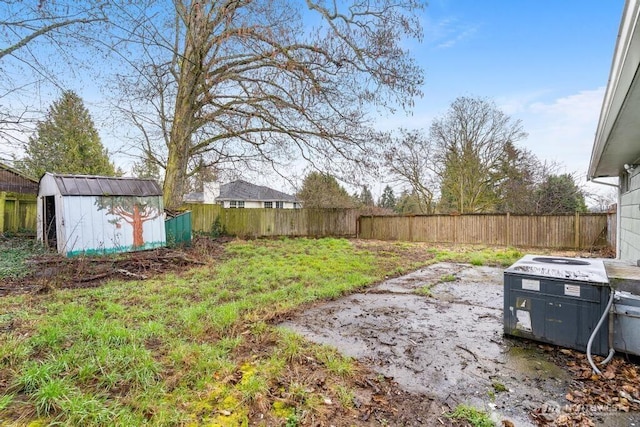 view of yard with a fenced backyard, cooling unit, a storage shed, and an outdoor structure