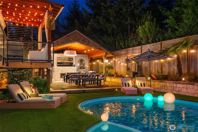 pool at twilight featuring a patio area, fence, and an outdoor pool