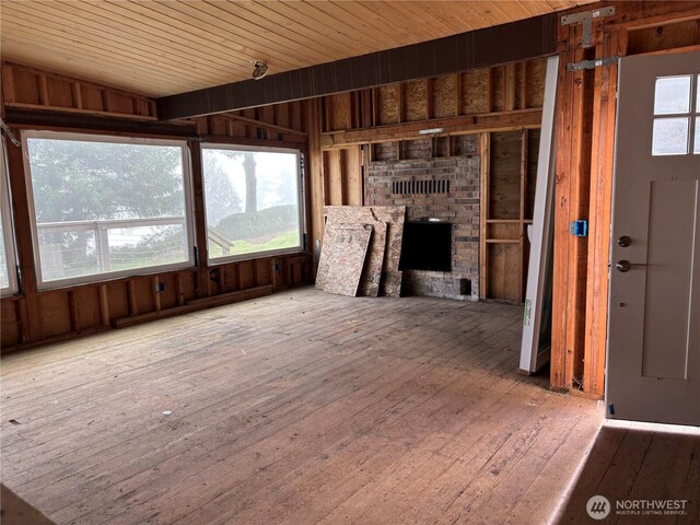 2459 Bretland Rd, Camano Island, WA 98282 - unfurnished living room featuring hardwood / wood-style floors, a brick fireplace, wood ceiling, and wood walls