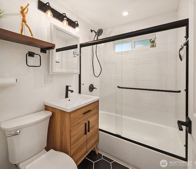 bathroom featuring recessed lighting, toilet, combined bath / shower with glass door, vanity, and tile patterned flooring