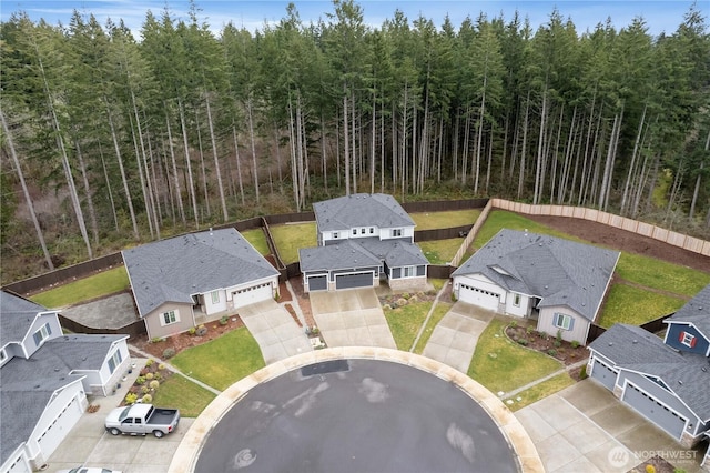 aerial view featuring a forest view and a residential view