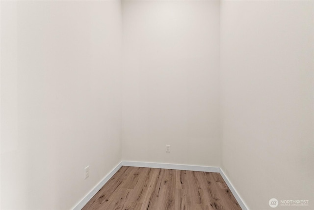 empty room with light wood-style flooring and baseboards