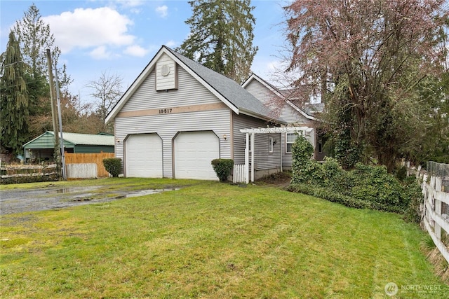 garage with driveway and fence