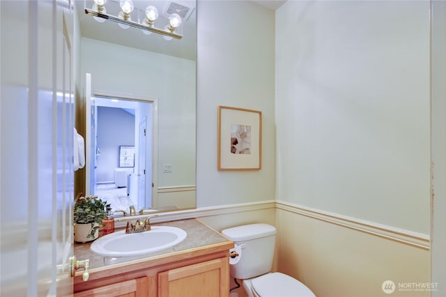 9418 NE Tidal Ct, Bainbridge Island, WA 98110 - half bathroom with visible vents, toilet, and vanity