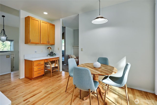9418 NE Tidal Ct, Bainbridge Island, WA 98110 - dining area featuring baseboards, light wood-type flooring, and a wealth of natural light