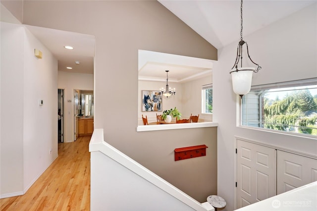 9418 NE Tidal Ct, Bainbridge Island, WA 98110 - interior space featuring recessed lighting, lofted ceiling, wood finished floors, and an inviting chandelier