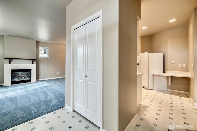 bathroom with tile patterned floors, a fireplace, baseboards, and recessed lighting