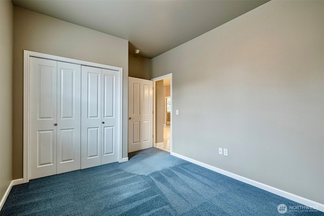 unfurnished bedroom featuring a closet, dark carpet, and baseboards