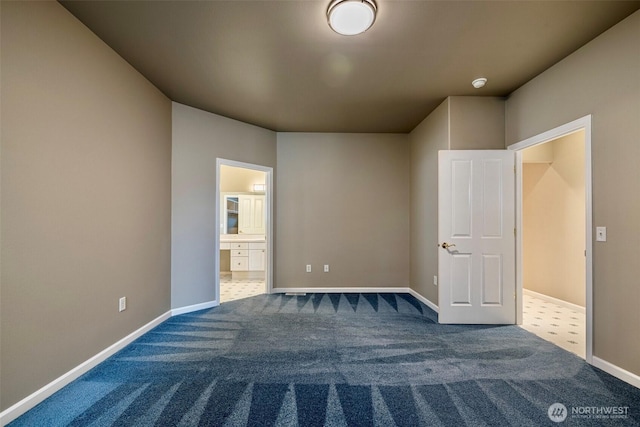 unfurnished bedroom with ensuite bathroom, carpet flooring, and baseboards