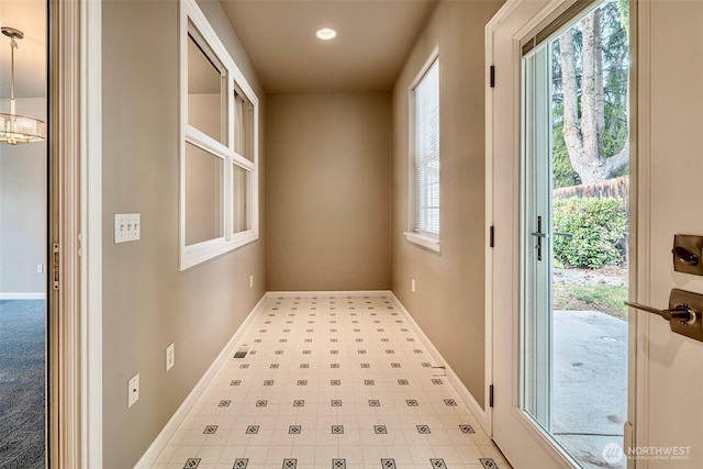 entryway with tile patterned floors and baseboards