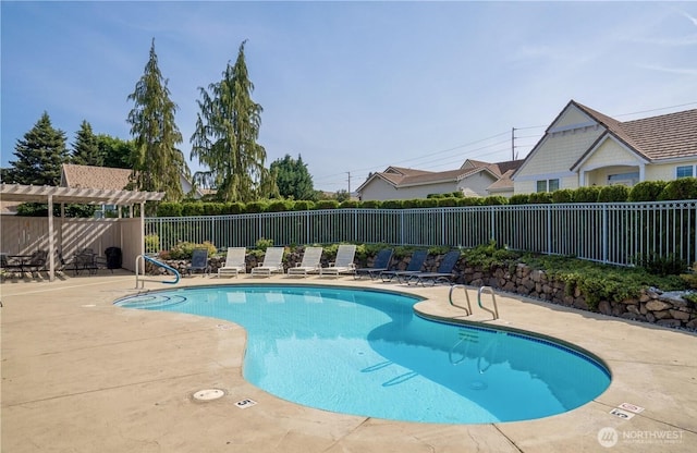 community pool featuring a patio area, fence, and a pergola