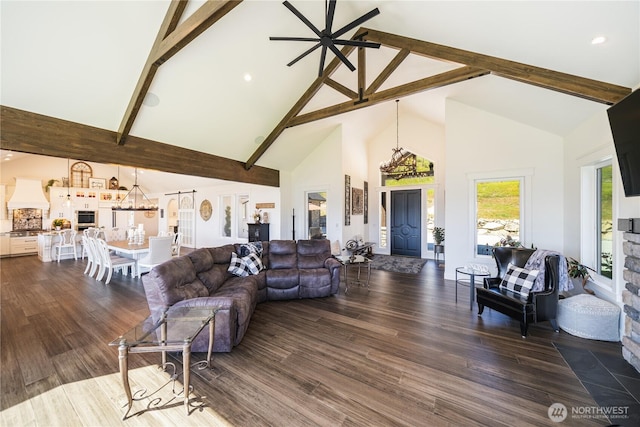 living room with ceiling fan with notable chandelier, high vaulted ceiling, dark wood-type flooring, and beam ceiling