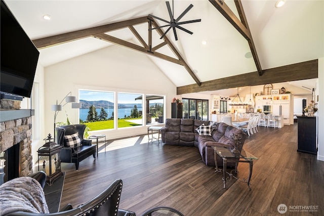 living area featuring dark wood-style floors, a fireplace, high vaulted ceiling, and beam ceiling