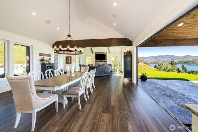 dining area featuring dark wood-style floors, recessed lighting, high vaulted ceiling, and an inviting chandelier