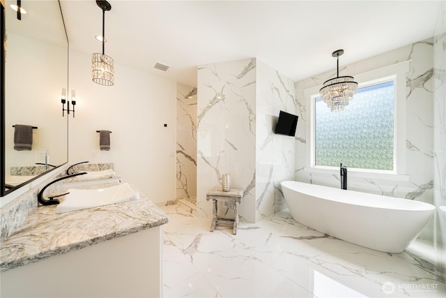 full bathroom featuring marble finish floor, stone wall, a sink, and visible vents