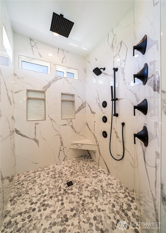 bathroom with a marble finish shower