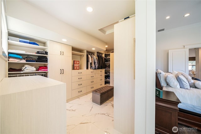 spacious closet with marble finish floor and visible vents