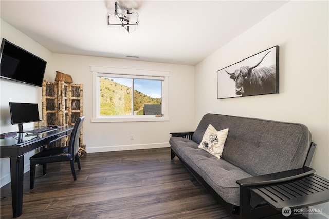 office with baseboards, visible vents, and wood finished floors