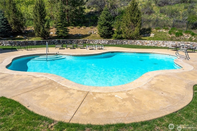 view of pool with a patio area, fence, and a fenced in pool