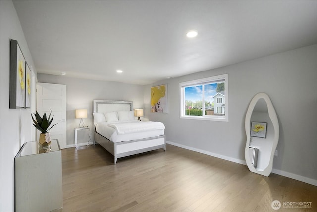 bedroom with recessed lighting, baseboards, and wood finished floors