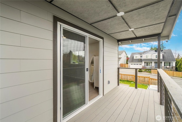 deck with a residential view and fence