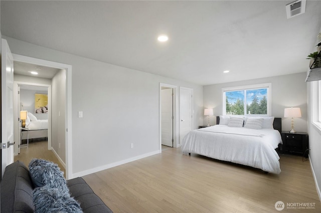 bedroom featuring recessed lighting, wood finished floors, visible vents, and baseboards