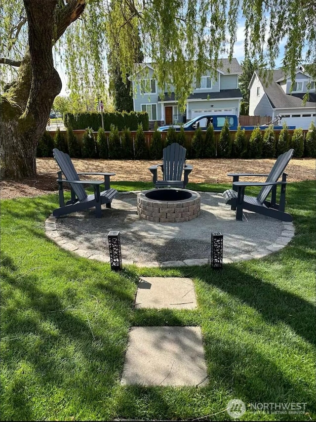 surrounding community with a yard, a patio, an outdoor fire pit, and fence