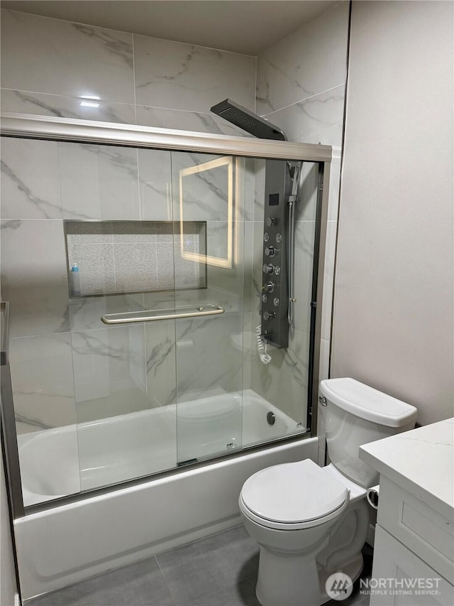 full bathroom with toilet, shower / bath combination with glass door, and vanity