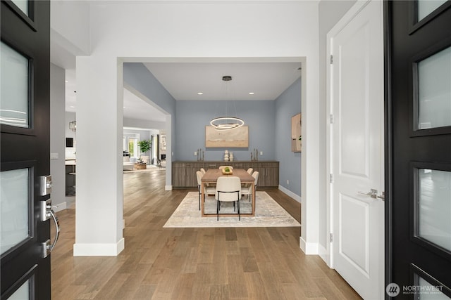 dining area with recessed lighting, baseboards, and wood finished floors