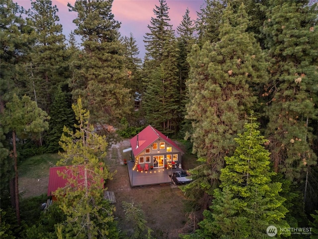 birds eye view of property with a wooded view