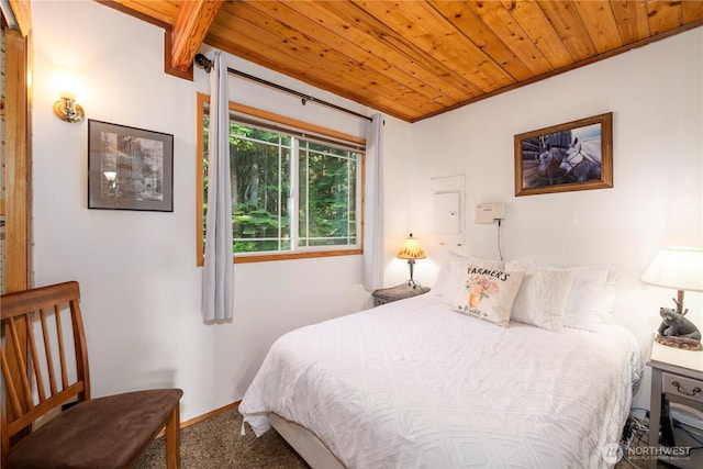 bedroom featuring carpet, wooden ceiling, and baseboards