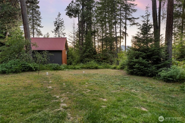 yard at dusk with an outbuilding