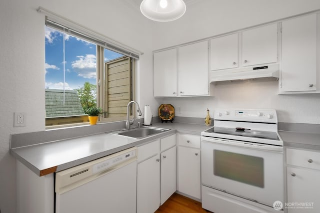 kitchen featuring white appliances, a sink, white cabinets, and under cabinet range hood