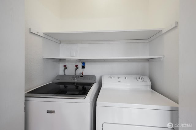 laundry area featuring washer and dryer and laundry area