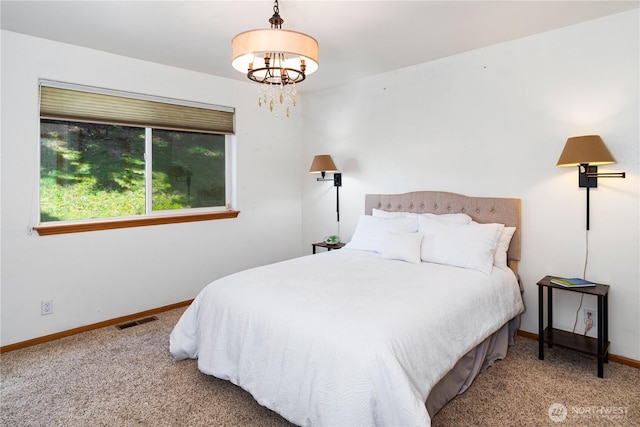 bedroom with carpet floors, baseboards, visible vents, and a chandelier