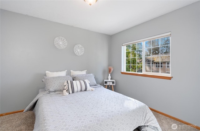 carpeted bedroom featuring baseboards