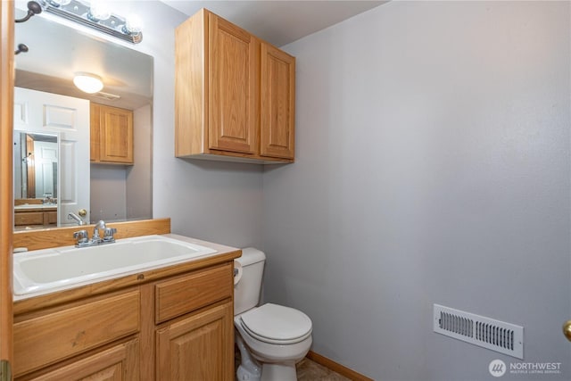 bathroom with baseboards, visible vents, vanity, and toilet