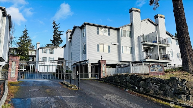 view of road featuring a gate, a gated entry, and a residential view