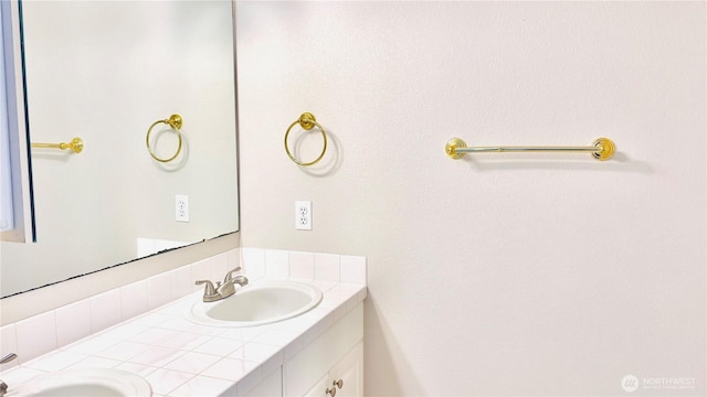 bathroom featuring a sink and double vanity