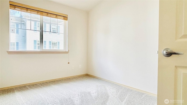 carpeted empty room with baseboards