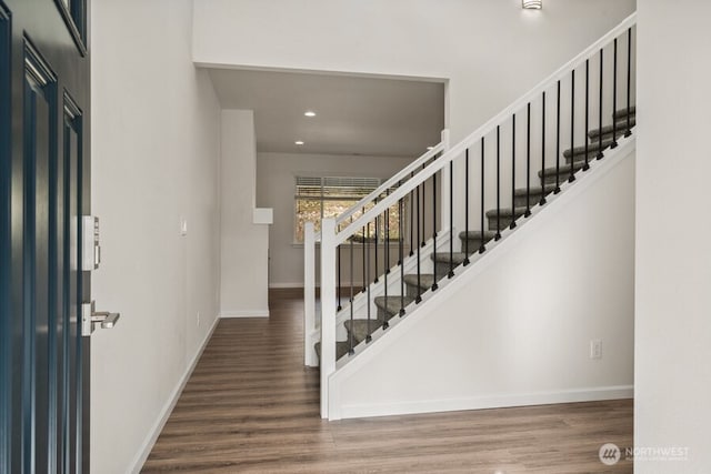 entryway featuring stairs, recessed lighting, baseboards, and wood finished floors