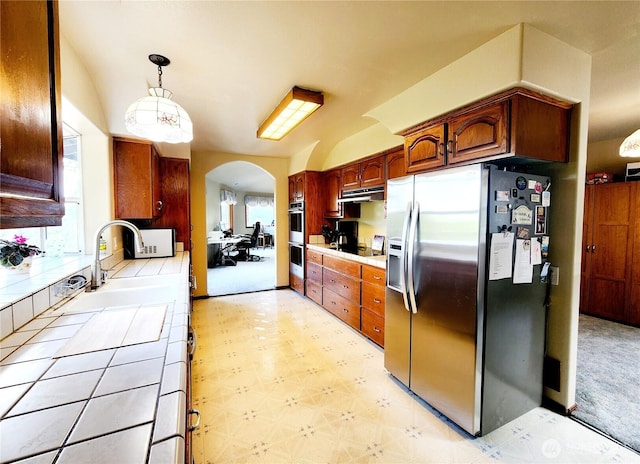176 Fager Hill Rd, Port Townsend, WA 98368 - kitchen featuring stainless steel appliances, arched walkways, light floors, tile counters, and a sink