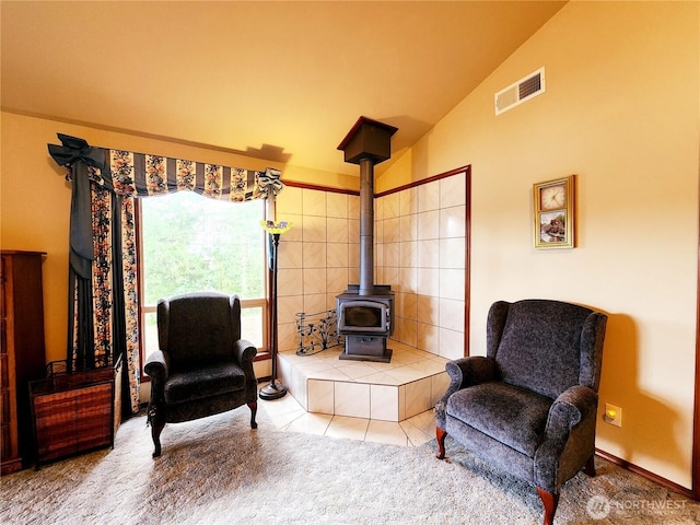 176 Fager Hill Rd, Port Townsend, WA 98368 - sitting room featuring a wood stove, vaulted ceiling, and tile patterned floors
