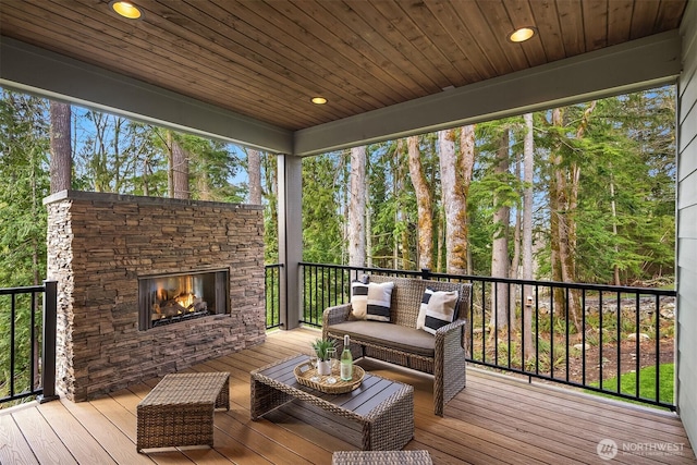 deck featuring an outdoor living space with a fireplace