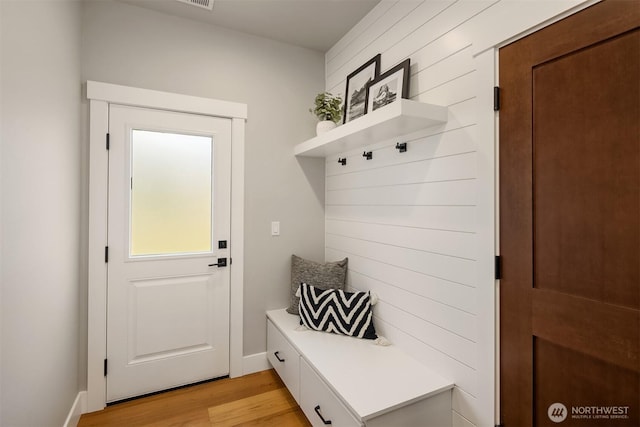 mudroom featuring light wood-style floors and baseboards