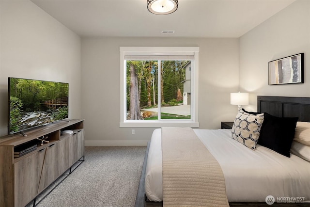 bedroom featuring light colored carpet, visible vents, and baseboards