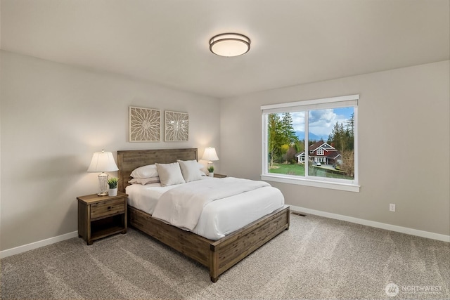 bedroom featuring carpet and baseboards