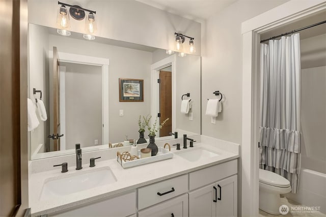 full bath with double vanity, a sink, toilet, and shower / tub combo with curtain