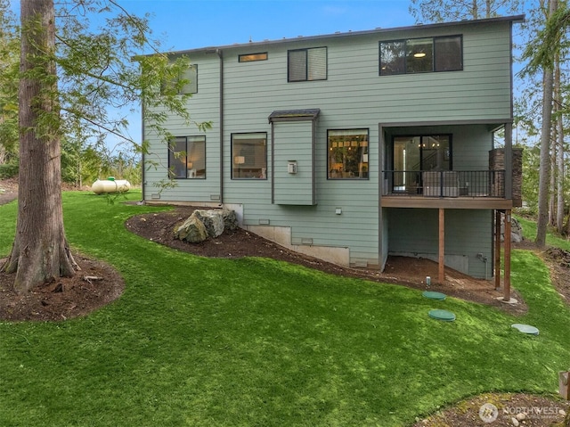 rear view of house with a yard