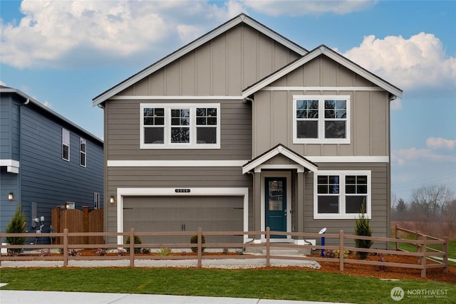 view of front facade with a garage, board and batten siding, and a fenced front yard